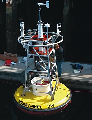 Photo showing NOAA scientists and technicians making final adjustments on the first buoy to carry equipment that measures ocean acidification. This buoy was deployed on June 7 in the Gulf of Alaska.