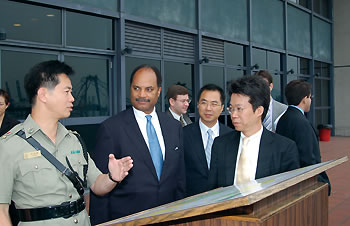 Photo showing Assistant Secretary for Export Enforcement Darryl W. Jackson (center) and Hong Kong Customs and Excise Department’s Head of Trade Controls Raymond Y.M. Wong (far right) touring the container port of Hong Kong with Hong Kong port security officials.